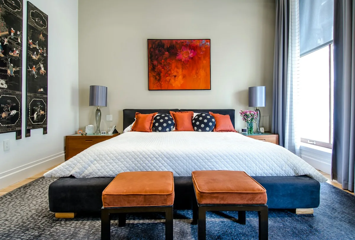 Bedroom with blue and white bedlinen and upholstered bench